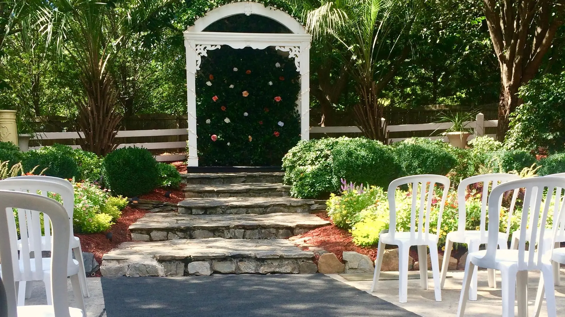 Ceremony arch along the stone path