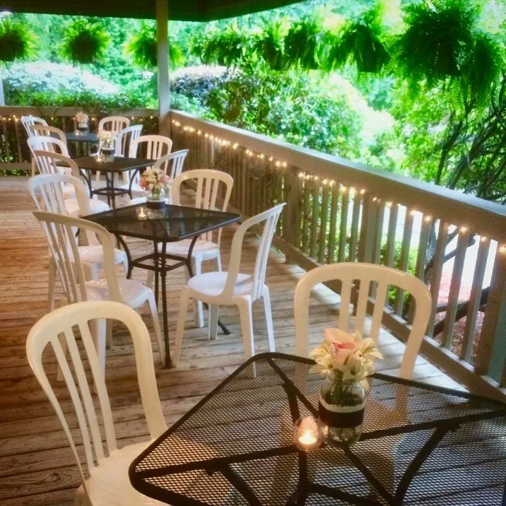 Deck tables under hanging greenery