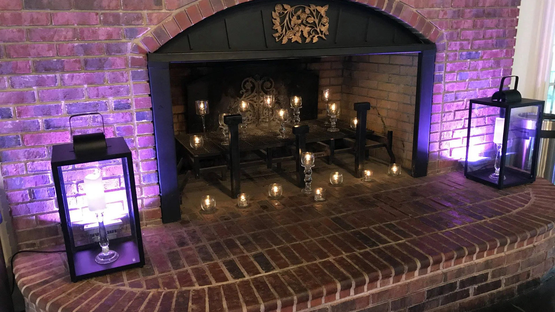 Fireplace glowing with candlelight