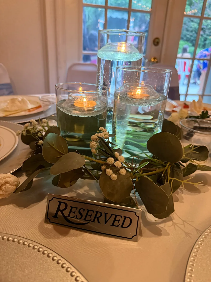 Floating candle centerpiece on a reserved table