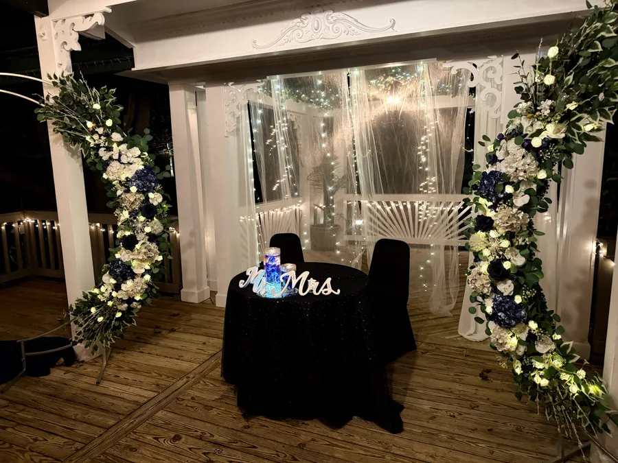 Floral arch behind the sweetheart table
