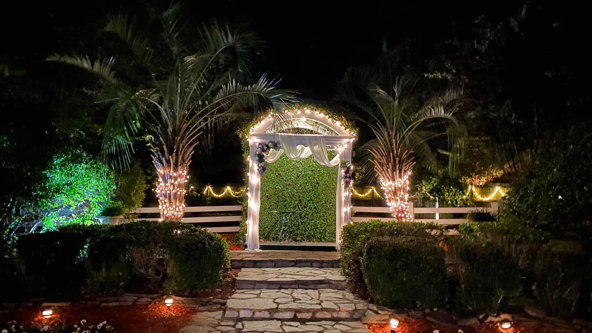Garden arbor lit at night