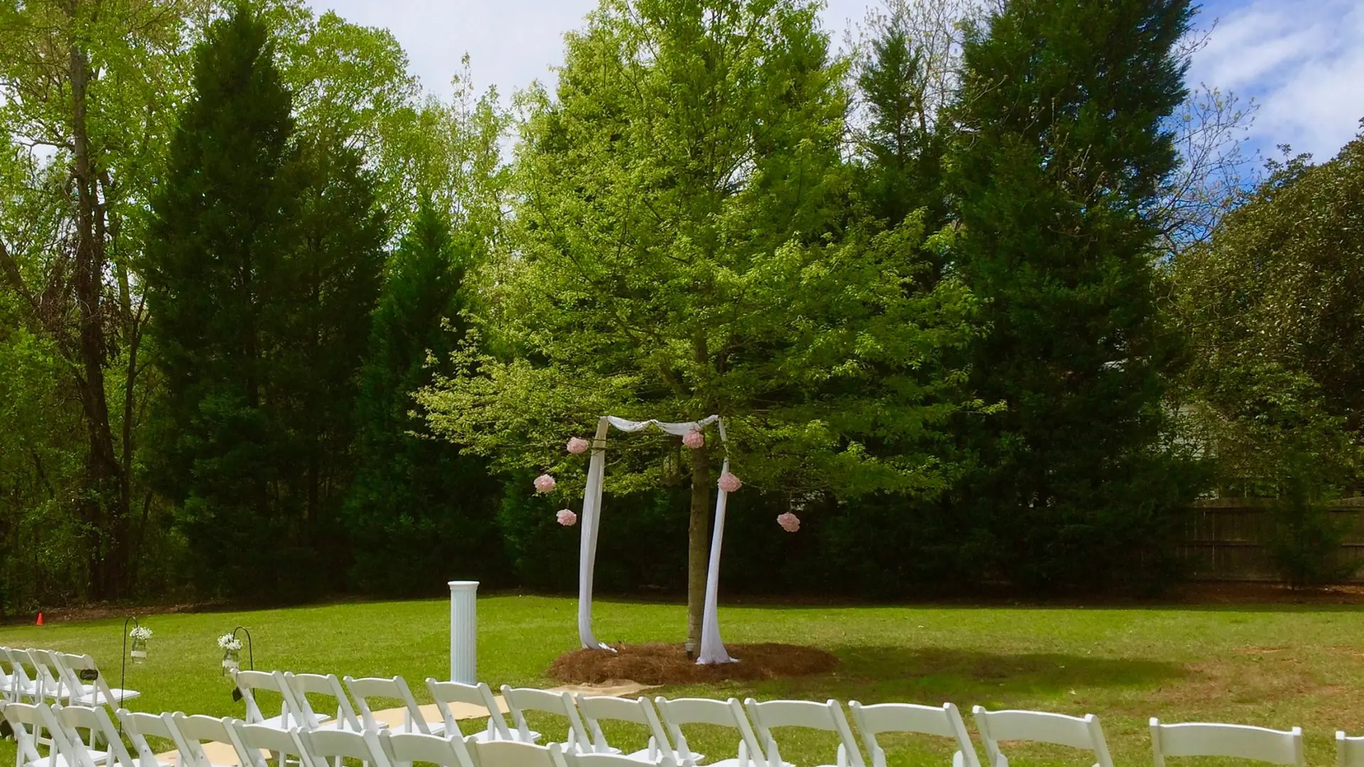 Garden ceremony setting with white chairs
