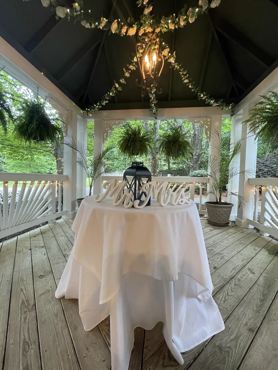 The gazebo dressed with drapery and a chandelier