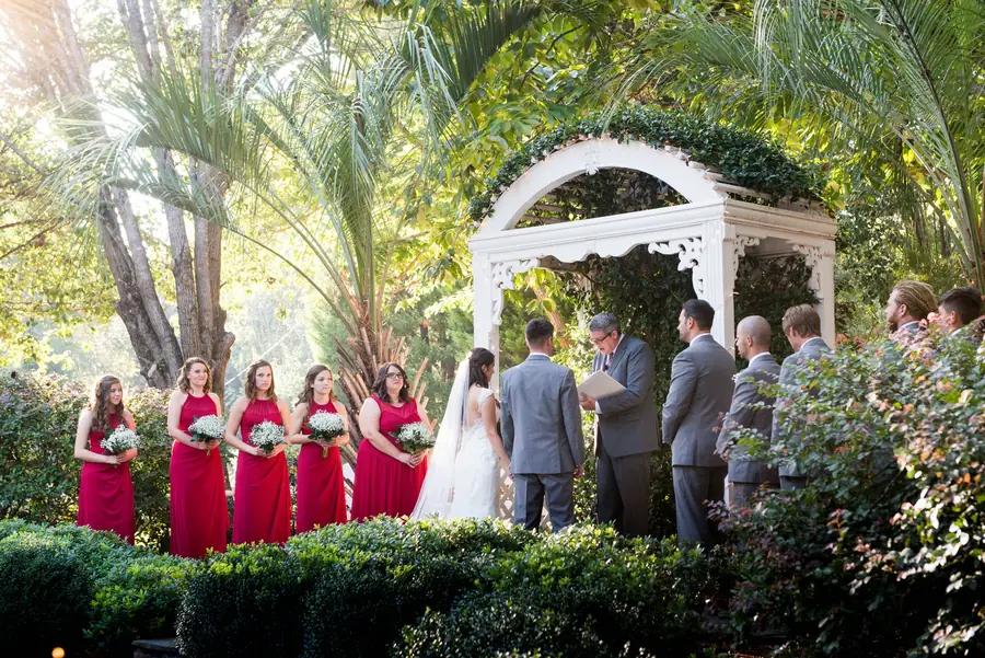 Wedding party gathered at the garden gazebo
