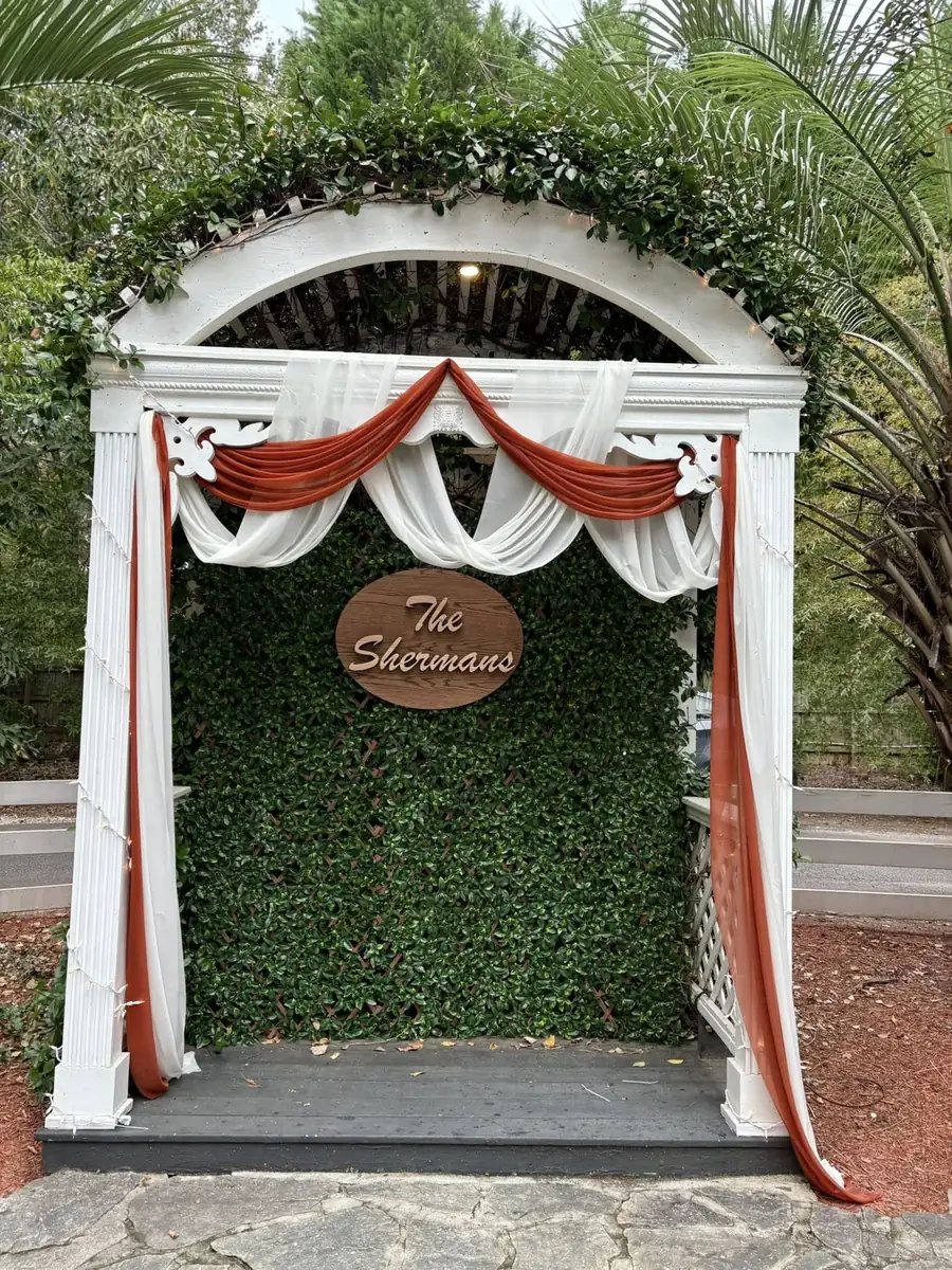 Greenery arch with terracotta draping