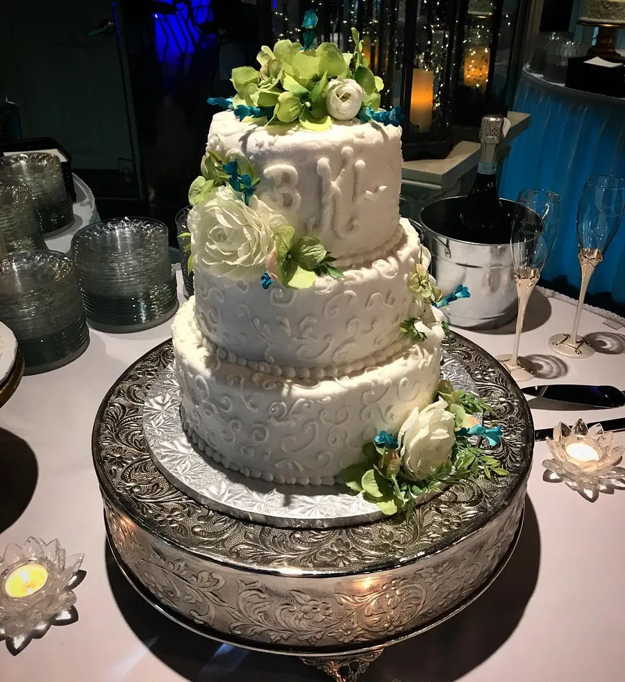 Wedding cake with greenery and white florals