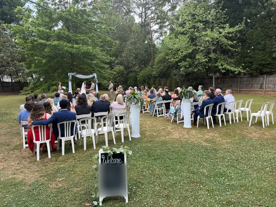 Lawn ceremony with guests seated under the trees