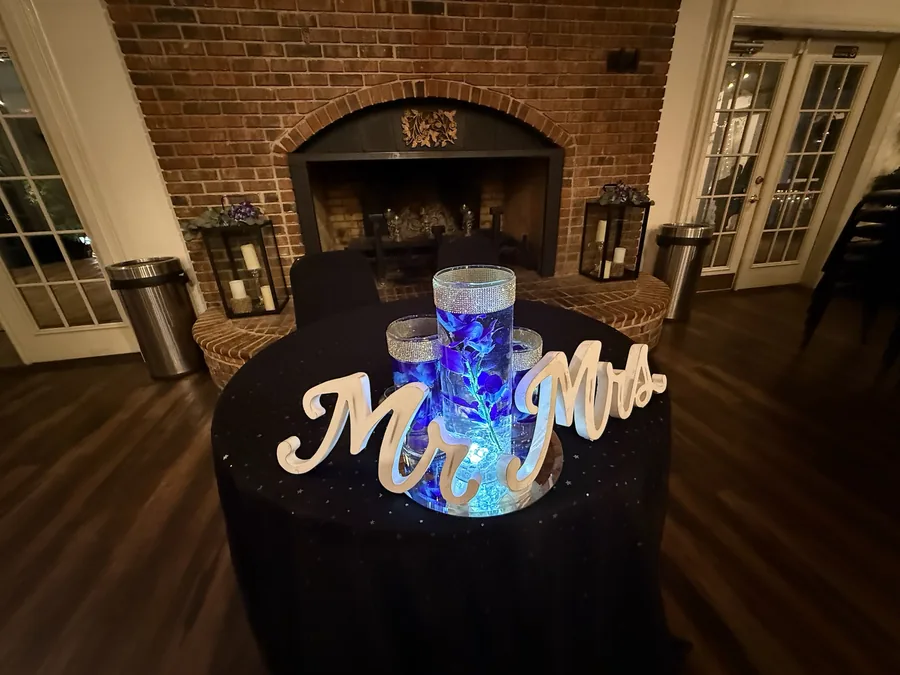 Mr and Mrs sweetheart table with uplighting