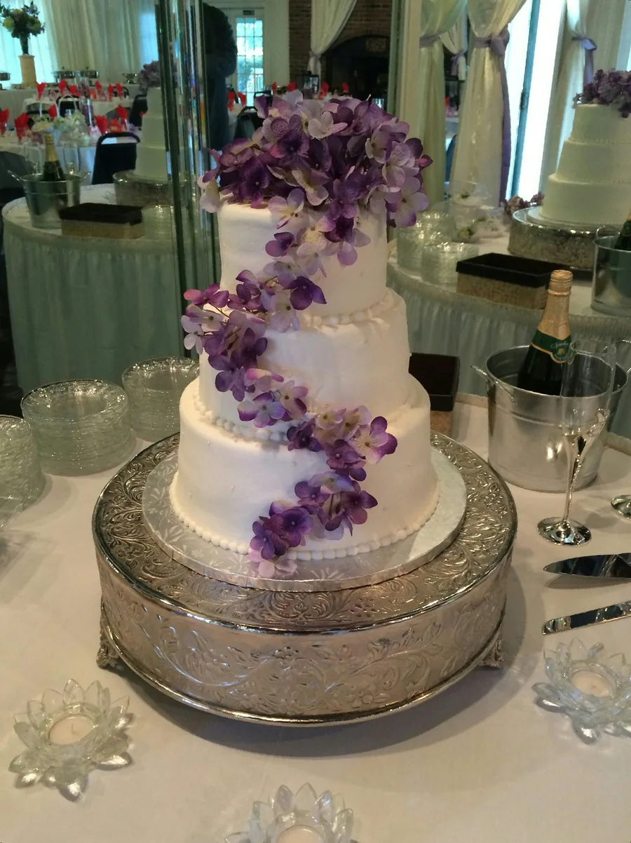 Wedding cake with a cascade of purple hydrangeas