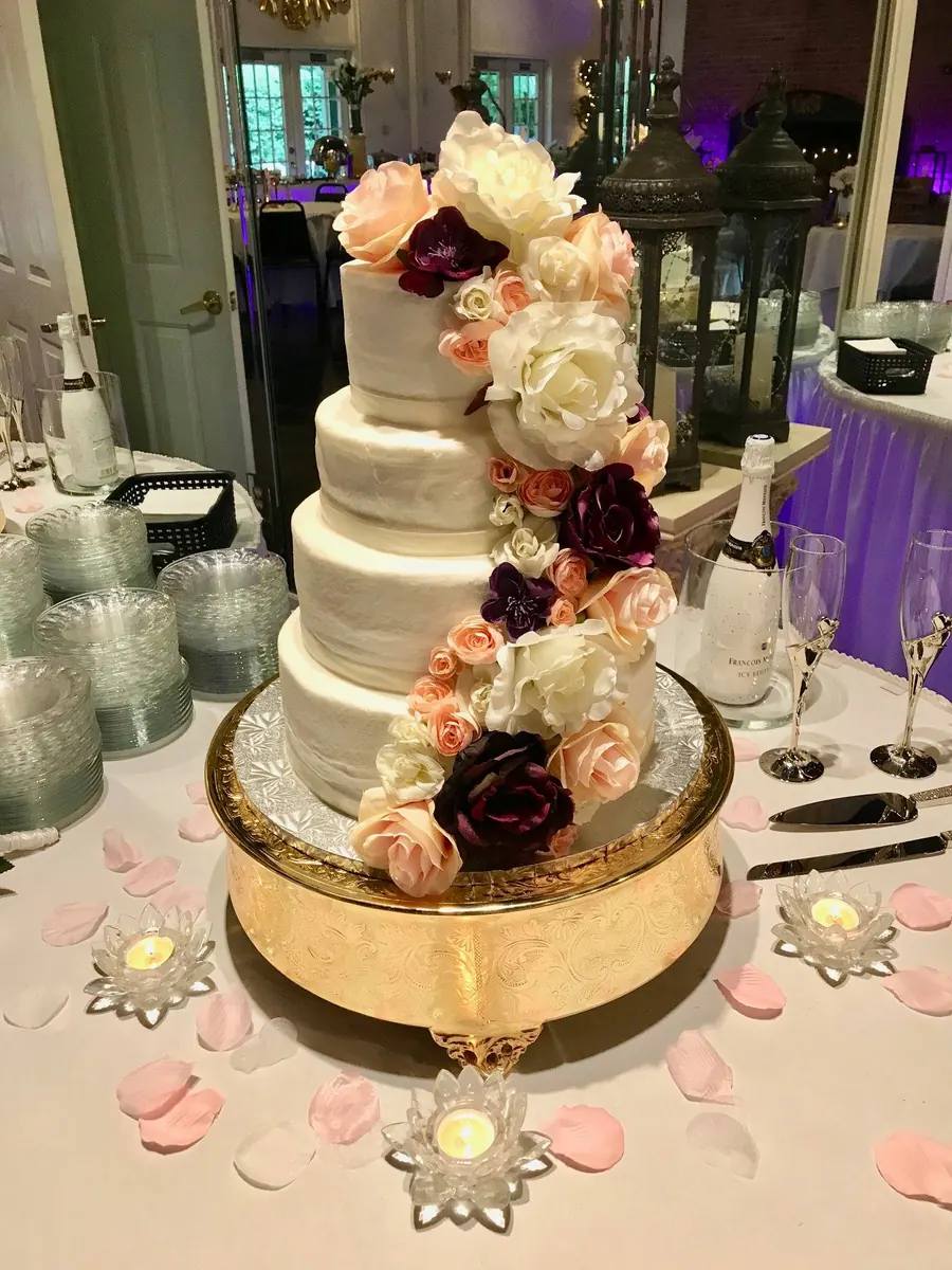 Wedding cake with a cascading rose spray