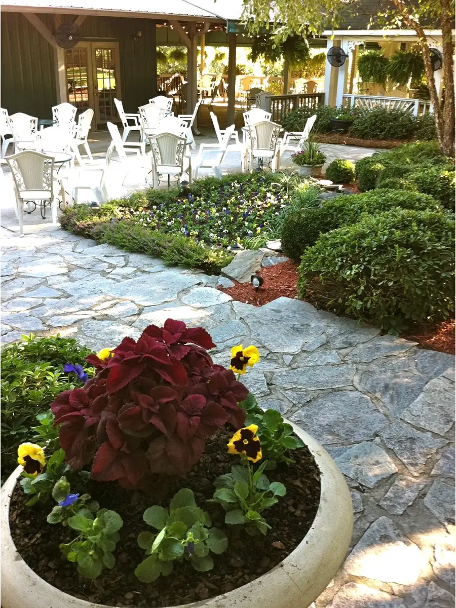 Stone patio with planters in bloom